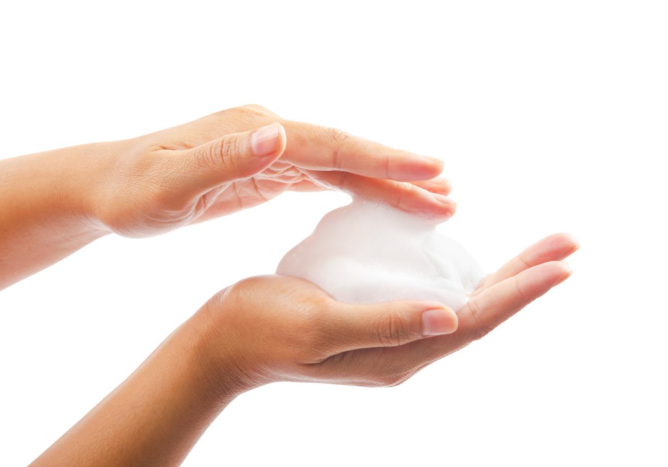 Hands holding cleansing foam
